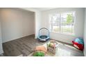 Inviting living room featuring a large window for natural light, laminate floors and toddler trampoline at 2916 W Bargello Ln, Monrovia, IN 46157