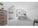 Bright bedroom featuring neutral tones, carpeted floors, and dormer windows, creating a cozy retreat at 300 N Church St, Arcadia, IN 46030