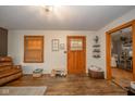 Spacious living room with hardwood floors, decorative lighting, and open floor plan leading to the kitchen at 3004 Sheridan St, Anderson, IN 46016