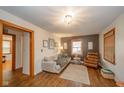 Cozy living room with hardwood floors, neutral paint, decorative lighting, and comfortable furniture at 3004 Sheridan St, Anderson, IN 46016