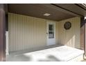 Covered porch area with white front door, vinyl siding, and unique octagon window at 310 W Jackson St, Alexandria, IN 46001