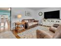 Cozy living room with leather furniture, hardwood floors, and a neutral color scheme at 3624 Woodcliff Dr, Indianapolis, IN 46203