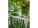 Secluded backyard with lush greenery, shed and a classic white picket fence, offering a serene escape at 3702 N Delaware St, Indianapolis, IN 46205