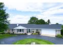 Classic ranch-style home with a well-maintained lawn and circular driveway, offering comfort and curb appeal at 3840 W 38Th St, Anderson, IN 46011