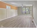 Bright living room with large windows, gray wood floors, and neutral paint colors offering a modern touch at 3898 S Randolph St, Indianapolis, IN 46227