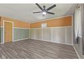 A spacious living room features updated flooring, neutral color scheme, and a modern ceiling fan at 3898 S Randolph St, Indianapolis, IN 46227
