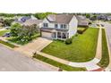 Spacious home featuring a large lawn, two-car garage, mature trees, and a welcoming front porch at 4157 Taunton Ct, Plainfield, IN 46168