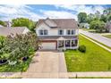 Aerial view of a home with a well-maintained lawn, two-car garage, and charming front porch at 4157 Taunton Ct, Plainfield, IN 46168