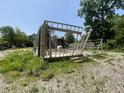 Framing of new construction with exposed beams and trusses on a lot with gravel and a partially collapsed building at 4566 Melbourne Rd, Indianapolis, IN 46228