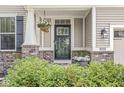 Charming front porch with decorative hanging plants and manicured bushes at 4642 Big Run Ct, Indianapolis, IN 46239