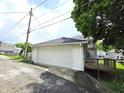 Spacious two-car garage with a private deck attached to the home, accessible via a concrete driveway at 509 Shelby St, Shelbyville, IN 46176