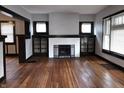 Inviting living room features a cozy fireplace, hardwood floors, and elegant dark trim, showcasing classic charm at 509 Shelby St, Shelbyville, IN 46176