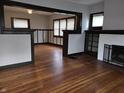 Bright living room boasts beautiful hardwood floors, a fireplace, and stylish dark trim, creating a warm atmosphere at 509 Shelby St, Shelbyville, IN 46176