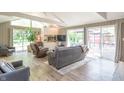 Bright living room with a vaulted ceiling, fireplace, and sliding doors to the backyard at 5315 Camden St, Indianapolis, IN 46227