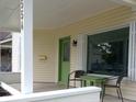 Inviting front porch with seating, a green door, and ample natural light at 554 W Taylor St, Shelbyville, IN 46176
