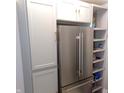 Kitchen showcasing gray cabinetry, a stainless steel refrigerator, and open shelving at 554 W Taylor St, Shelbyville, IN 46176