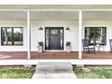 Inviting front porch featuring rocking chairs, decorative plants, and stylish lighting fixtures adding charm and character at 5710 W 650 N, Thorntown, IN 46071