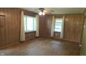 Spacious living area featuring wood paneling, hardwood floors, and plenty of natural light at 6484 S State Road 39, Clayton, IN 46118