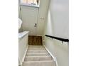 Staircase leading to the upper level, showcasing carpeted steps and handrail at 6927 Havenmoor Pl, Indianapolis, IN 46250