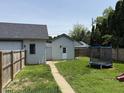 Backyard featuring detached garage, trampoline, and plenty of green space for outdoor activities at 707 S Harrison St, Alexandria, IN 46001