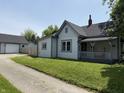 View of single story house with driveway and garage behind the fence on a sunny day at 707 S Harrison St, Alexandria, IN 46001
