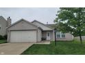 Inviting single-story home with a two-car garage, landscaped front yard, and a welcoming entrance at 713 Driftwood Cir, Danville, IN 46122