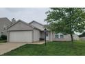 Inviting single-story home with a two-car garage, landscaped front yard, and a welcoming entrance at 713 Driftwood Cir, Danville, IN 46122