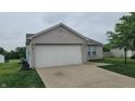 Home featuring a two-car garage, complementing the well-maintained landscaping at 713 Driftwood Cir, Danville, IN 46122