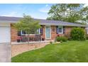 Inviting porch with seating area and attractive landscaping, offering curb appeal and charm at 762 N Dellasburg Rd, Columbus, IN 47203