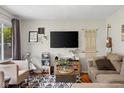 Comfortable living room showcasing modern decor, including a large screen TV and stylish furnishings at 762 N Dellasburg Rd, Columbus, IN 47203
