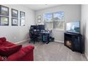 Comfortable bedroom with a workstation, decorative fireplace, and a large window providing natural light at 7834 Fairwood Blvd, Plainfield, IN 46168