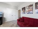 Bedroom with a red couch and a closet, perfect for relaxing or setting up a guest room at 7834 Fairwood Blvd, Plainfield, IN 46168