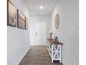 Inviting entryway featuring wood-look floors, stylish console table with decor, and attractive wall art at 7834 Fairwood Blvd, Plainfield, IN 46168