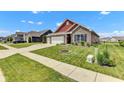 Inviting single-Gathering home with a well-kept lawn, brick accents, and convenient three-car garage at 8044 Yarmouth Way, Indianapolis, IN 46239