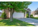Charming brick home featuring an attached two-car garage and well-maintained landscaping at 8199 Sydney Ln, Avon, IN 46123