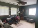 Bedroom featuring a large desk with computer and ceiling fan at 828 N Clarkdale Dr, Muncie, IN 47304