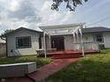 Charming home featuring a cozy red deck with pergola, perfect for outdoor relaxation and entertaining at 8445 Montery Rd, Indianapolis, IN 46226