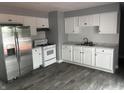 Stylish updated kitchen with white cabinets, stainless steel appliances, and a modern aesthetic at 8445 Montery Rd, Indianapolis, IN 46226