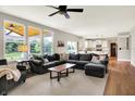 Spacious living room featuring a large sectional sofa, hardwood floors, and views of the backyard at 848 Silverheels Dr, Westfield, IN 46074