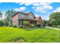 Beautiful 2-story home with landscaped lawn, charming front porch, and attached two-car garage at 8619 Wrangler Ct, Indianapolis, IN 46217