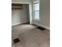 Cozy bedroom with plush carpeting, closet, and window, perfect for relaxation at 88 N 15Th Ave, Beech Grove, IN 46107
