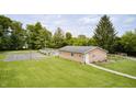 Expansive backyard featuring an in-ground pool, basketball court and charming single-story home at 8879 W County Road 700 S, Coatesville, IN 46121
