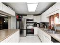 Well-equipped kitchen featuring stainless steel appliances, white cabinetry, and plenty of counter space at 8879 W County Road 700 S, Coatesville, IN 46121