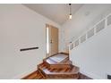 Inviting entryway with wood-look flooring, a coat rack and a staircase at 9054 Cornucopia Dr, Indianapolis, IN 46268
