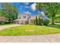 Lovely townhome featuring a well-manicured lawn, brick accents, and a cozy front entrance at 9054 Cornucopia Dr, Indianapolis, IN 46268