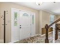 Bright entryway with decorative glass sidelights and tile flooring at 9221 Holyoke Ct, Indianapolis, IN 46268