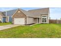 Single Gathering house with brick and vinyl exterior, two car garage, and green lawn at 929 Capricorn Dr, Franklin, IN 46131