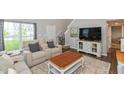 Bright living room with comfortable seating, large windows, and a view of the front yard at 929 Capricorn Dr, Franklin, IN 46131