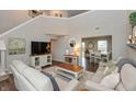 Open-concept living room with neutral tones, high ceilings, and seamless access to the dining area at 929 Capricorn Dr, Franklin, IN 46131