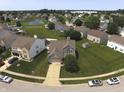 Expansive aerial view of a residential neighborhood with tree-lined streets and a central pond at 9704 Gull Lake Dr, Indianapolis, IN 46239